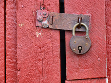 Padlock On Old Red Wooden Door