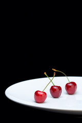 Wall Mural - three cherries on a plate