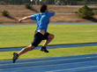 man running on a blue racetrack