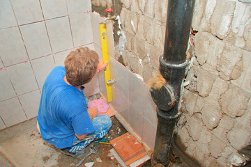 plumber placing tiles