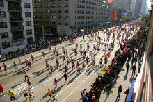 People Running Down The Street In A Marathon