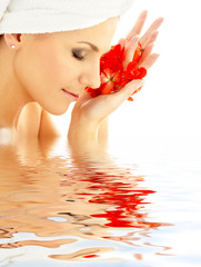 lady with red petals in water