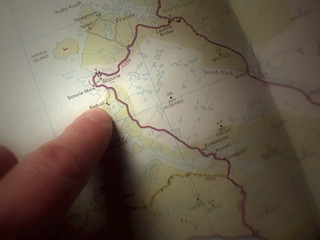 finger pointing at map