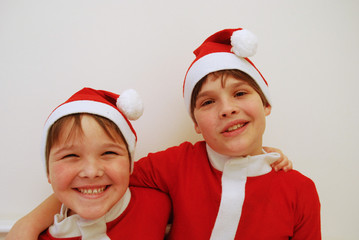 two lovely boys dressed as santa claus