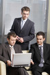 © endostock - group of three businessmen working on laptop in the office