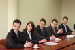 © endostock - group of 5 business persons sitting at the table
