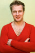 smiling man in a red sweater