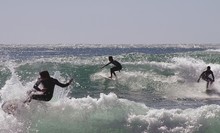 Three Surfers