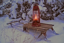 Oil Lamp On An Old Sled In Snowy Winter Evening
