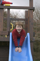 Wall Mural - boy on a garden slide