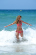 © Nick Stubbs - sexy fit young woman being splashed by a wave