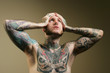 © MaxFX - tattooed man holding his head