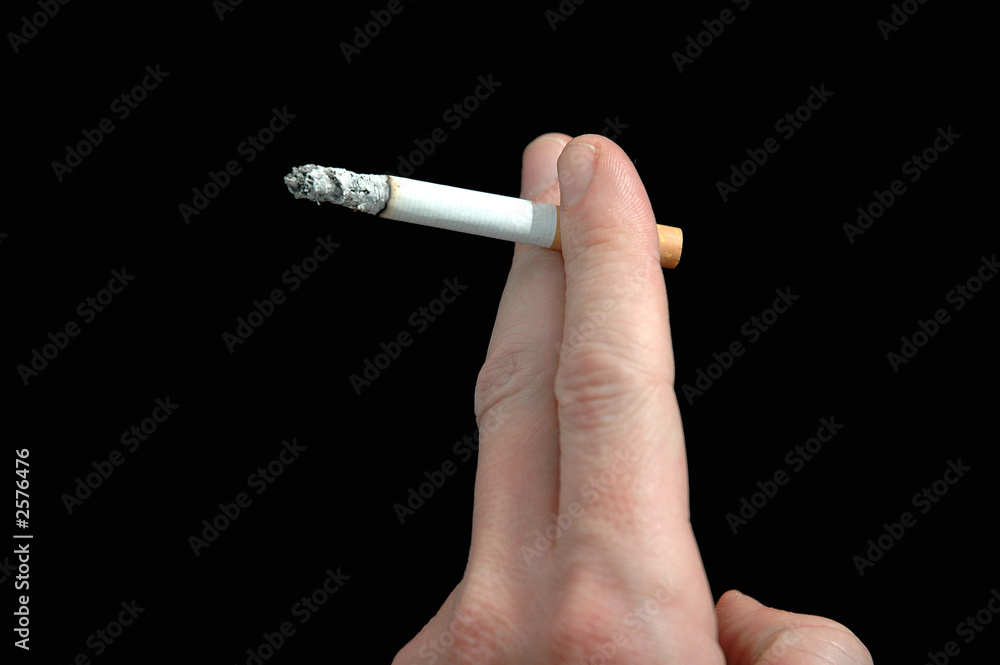 cigarette in fingers fingers holding cigarette Stock Photo