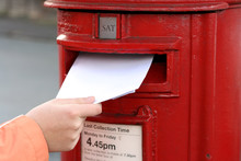 Posting Letter To Red British Postbox