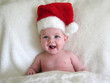 happy baby wearing santa hat