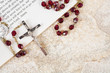 rosary beads on a book of psalms