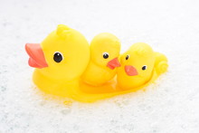 Three Rubber Ducks In Foam Water