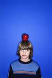 Fototapeta Mapy - caucasian boy with apple on his head.