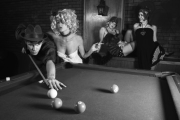 retro male shooting pool with three retro females watching.