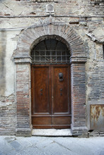 Wooden Door With Brick Archway.