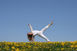 © Studio Light & Shade - smiling young woman exercising in dandelion field