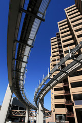 Fototapete - futuristic monorail going around skyscrapers