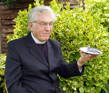 Vicar Passing The Plate For The Collection  