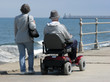 Elderly man riding motorized wheelchair 