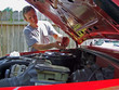 © Sheri Armstrong - man working on car