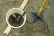 © Ron Greer - sand in bucket and tamper for patio work