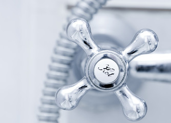 Bath tap with hot sign  close up