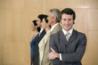 © carlosseller - Confident businessman with team behind him