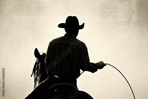 Cuadros en Lienzo cowboy at the rodeo - shot backlit against dust, added grain