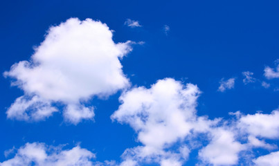 Wall Mural - white clouds against a deep blue sky