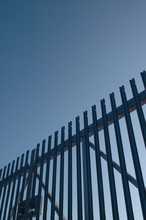 Steel Security Gates Against Blue Sky