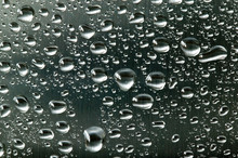 Water Droplets On A Brushed Steel Surface.