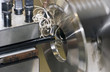 Fine turnings fly off a fast spinning metal lathe