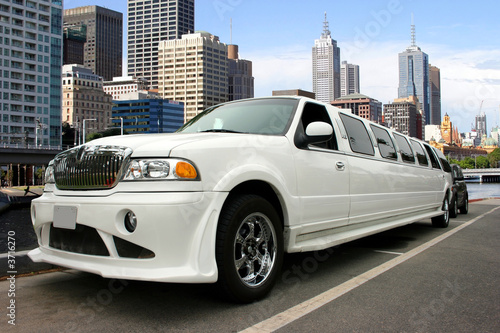 Naklejka dekoracyjna White classy limousine waterfront and skyscrapers