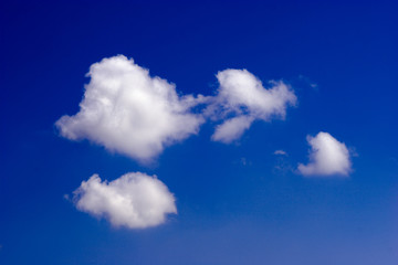 four wonderful clouds in vivid deep blue skyes