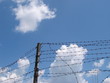 Cloudy blue sky with rugged wire fence 3