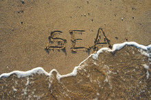 Sea Script On Sand, Waves Washing It