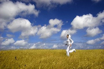 Poster - Bautiful woman running on a golden meadow