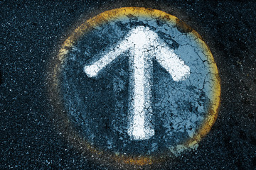 Arrow sign on an old asphalt texture background