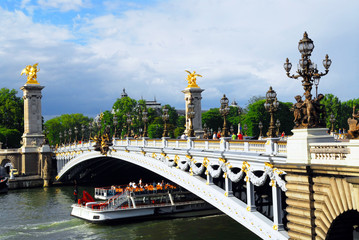 Alexander the Third bridge and Seine cruise boat in Paris,