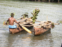 Melanesian In Wooden Outrigger Canoe
