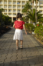 Young Child Walking With Hotel Key In Her Hann