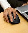 Woman's hand holding wireless mouse.