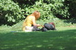 © oscar williams - Couple relaxing on the grass.
