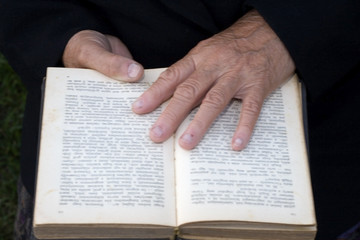 Wall Mural - Senior's hands on old book