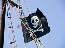 Pirate Flag On The Sailboat Waving In The Wind